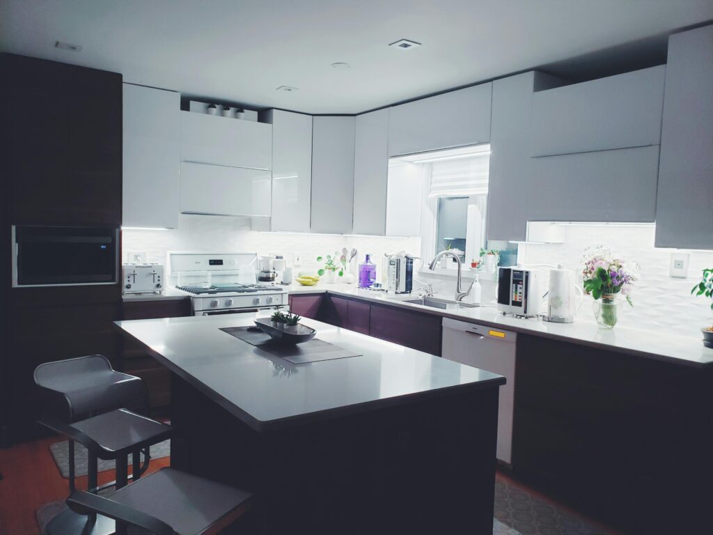 Contemporary kitchen interior with sleek white cabinets and island, perfect for a minimalist aesthetic.
